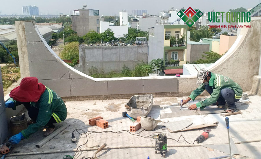 Đội thợ giỏi nghệ của Công ty Việt Quang Group đang thi công cắt gạch để ốp lát gạch tường trên sân thượng